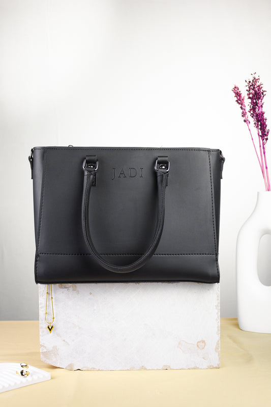 Soléa Handbag in Black — minimal structured handbag by JADI Pakistan